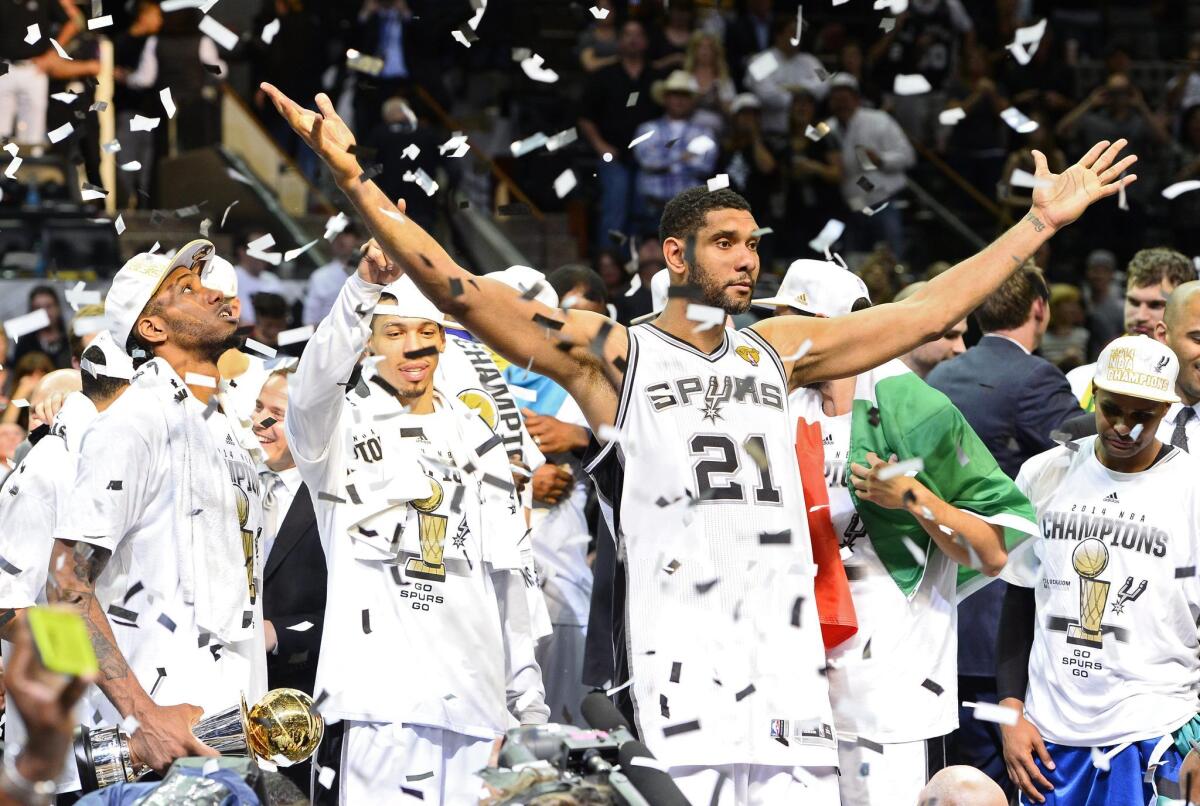 San Antonio Spurs' Tim Duncan celebrates beating the Miami Heat in the NBA Finals.