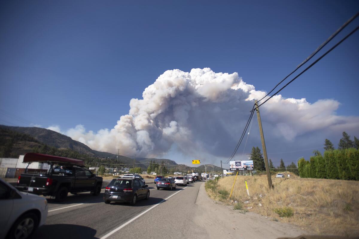 Smoke from a fast-burning wildfire billowing in the sky in northwest Canada