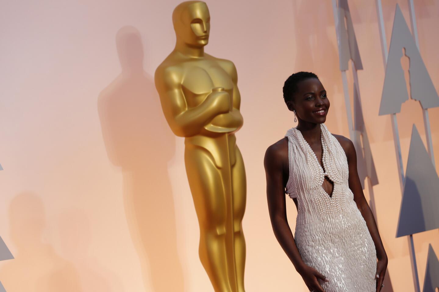 Lupita Nyong'o wears a Calvin Klein gown with 6,000 hand-sewn pearls to the 87th Academy Awards.