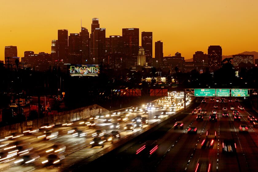 LOS ANGELES, CALIF. - NOV. 24, 2021. Traffic streams along the San Bernardino Freeway in downtown Los Angeles on Thanksgiving getaway day on Wednesday, Nov. 24, 2021. (Luis Sinco / Los Angeles Times)