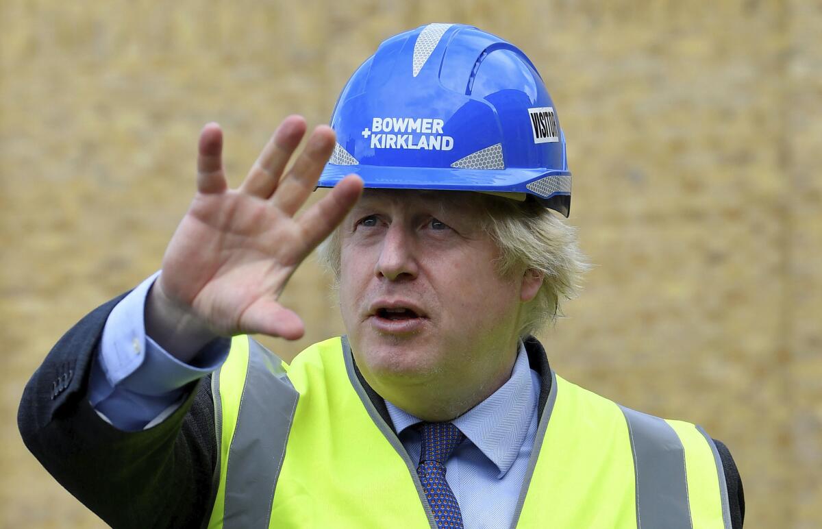 Britain's Prime Minister Boris Johnson visits the construction site of Ealing Fields High School in west London on Monday.