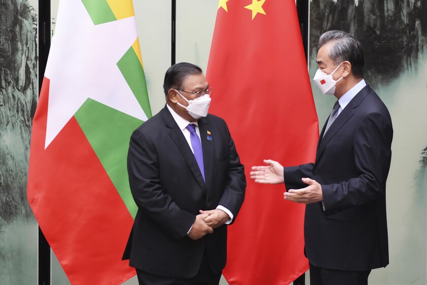 In this photo released by China's Xinhua News Agency, Chinese Foreign Minister Wang Yi meets with Myanmar's Foreign Minister Wunna Maung Lwin in Tunxi in eastern China's Anhui Province, Friday, April 1, 2022. China says it will back neighbor Myanmar "no matter how the situation changes," in the latest show of unequivocal Chinese support for the ruling military council that seized power last year. (Zhou Mu/Xinhua via AP)