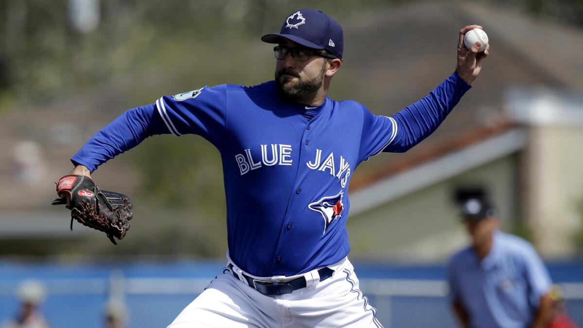 Toronto pitcher T.J. House delivers a pitch during an exhibition game March 7.