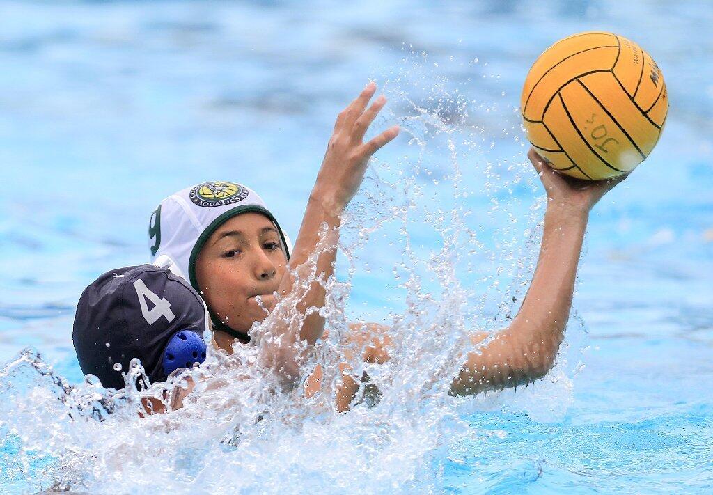 Costa Mesa Aquatics Club's Stewart Campbell, right, looks to pass as he is defended by Los Angeles Water Polo Club's Noah David, left, during a USA Junior Olympics semifinal match at Mater Dei High in Santa Ana on Tuesday.