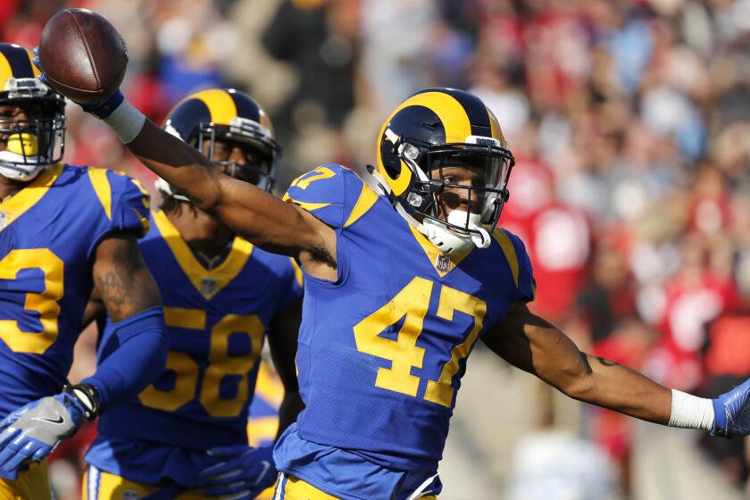 Rams cornerback Kevin Peterson (47)celebrates with teammates Carlos Thompson (53) and Cory Littleton (58) after intercepting a pass from 49ers quarterback Jimmy Garoppolo on Dec. 31.