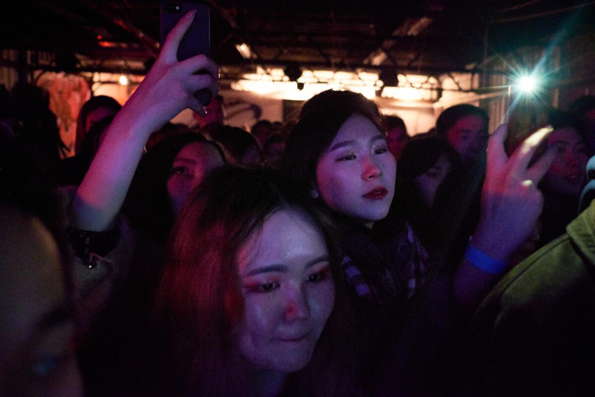 Fans crowd the stage during the concert at Grunge Bar.