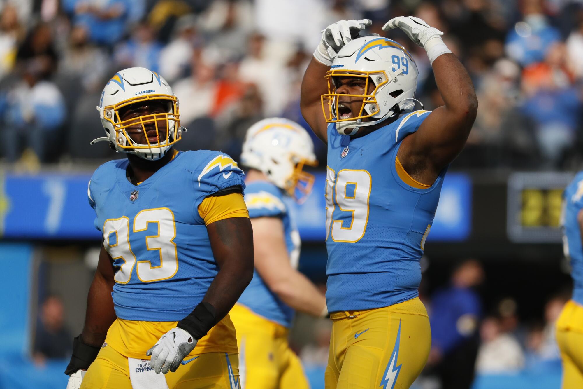 Chargers defensive end Jerry Tillery celebrates next to teammate Justin Jones after sacking Broncos quarterback Drew Lock.