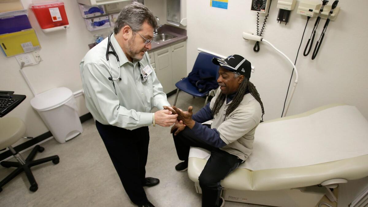 Dr. Leonid Basovich examines Medi-Cal patient Michael Epps at the WellSpace Clinic in Sacramento.