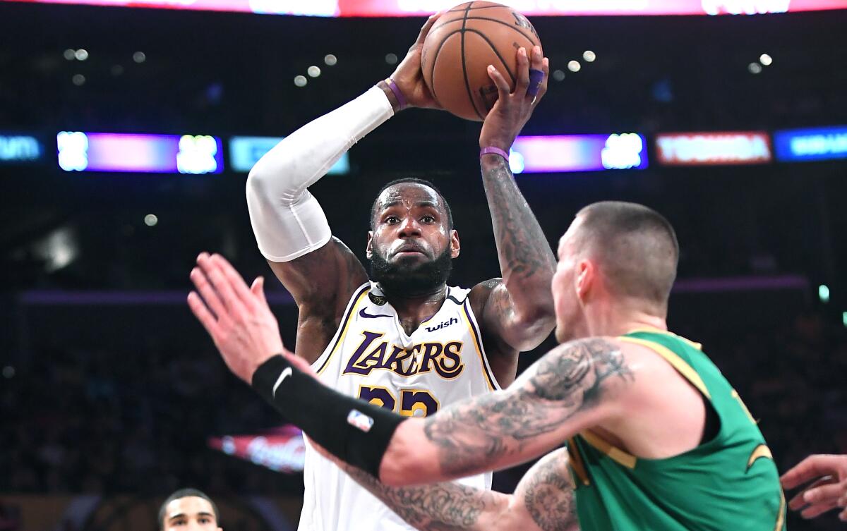 Lakers star LeBron James drives to the basket during a 114-112 victory over the Boston Celtics at Staples Center on Sunday.