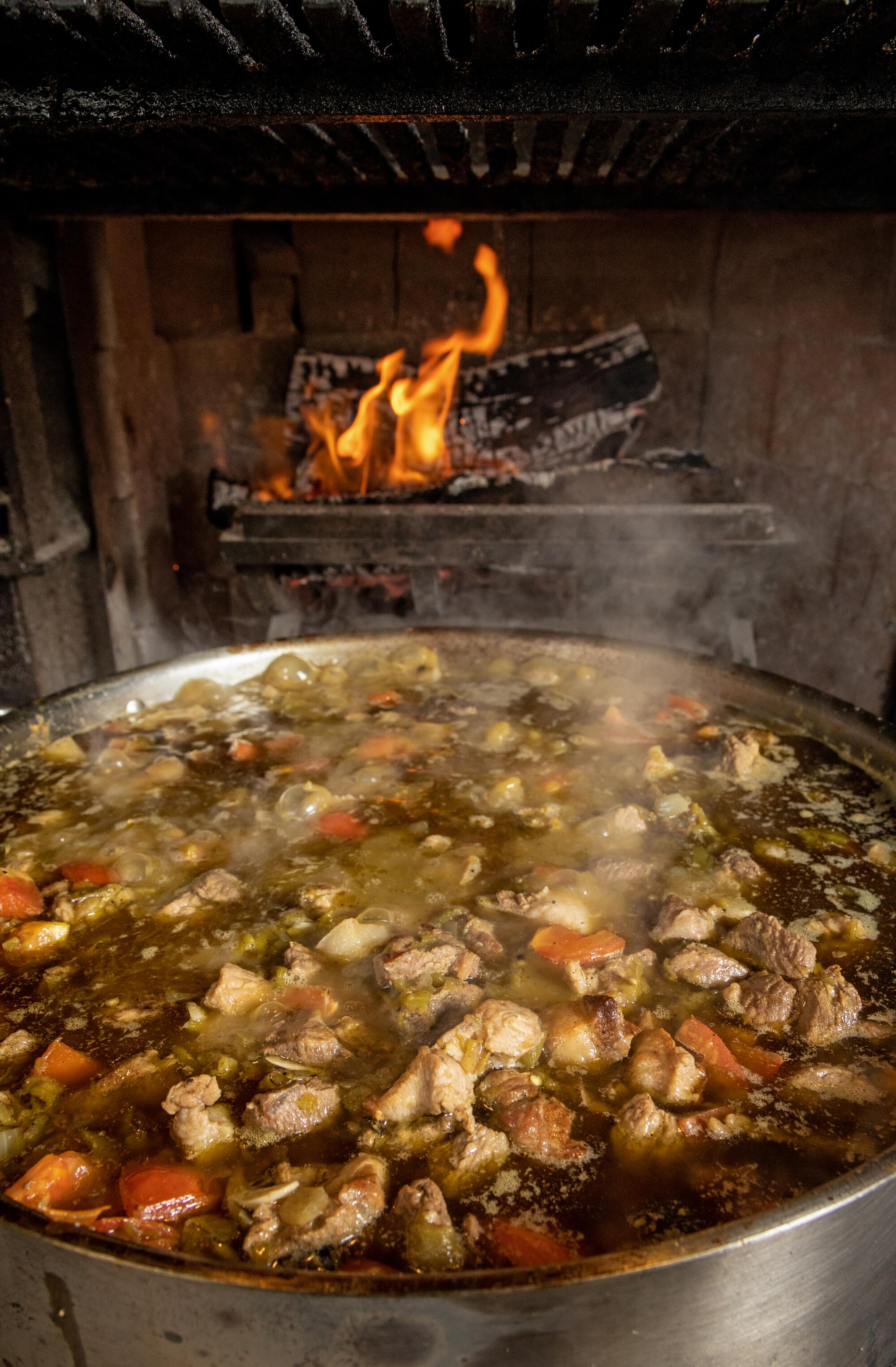 The green chile and pork stew at Dunsmoor in L.A. simmers on a hearth.
