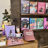 Romance books and merchandise on display at a bookstore.