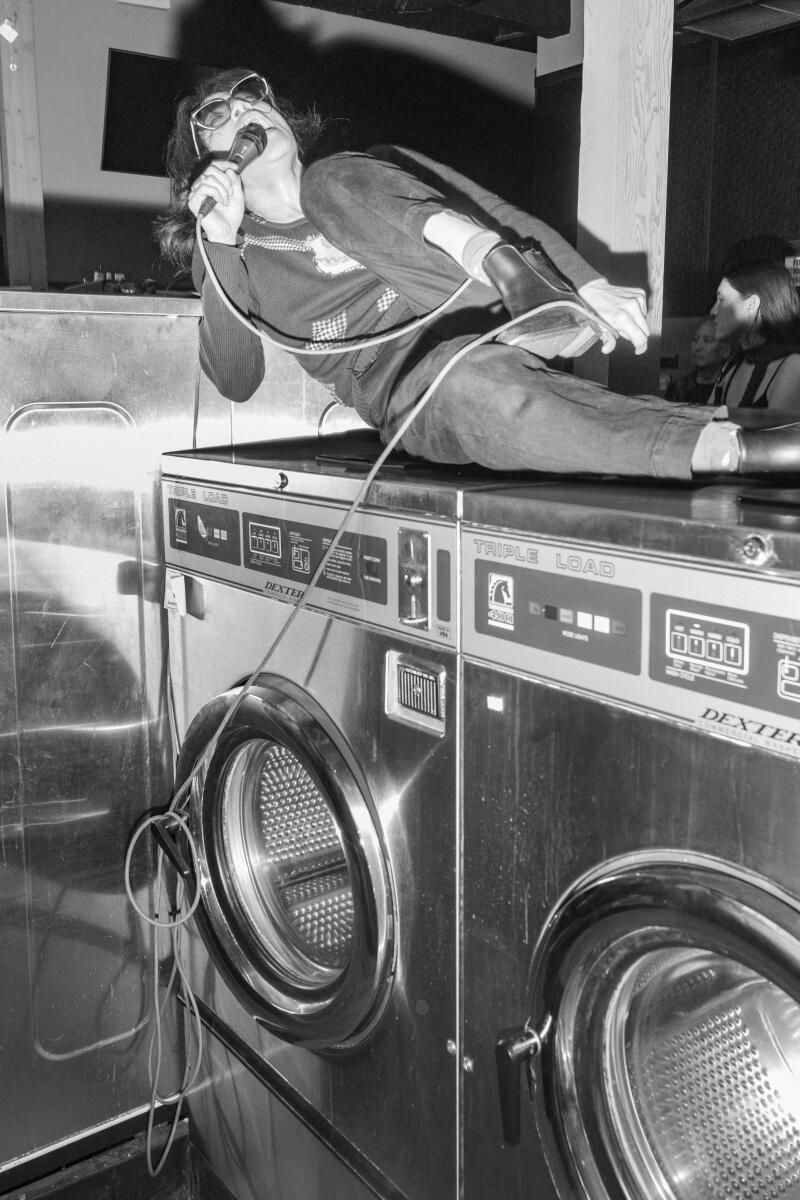 Muscle Beach performs on top of laundry machines at Laundry Wand.