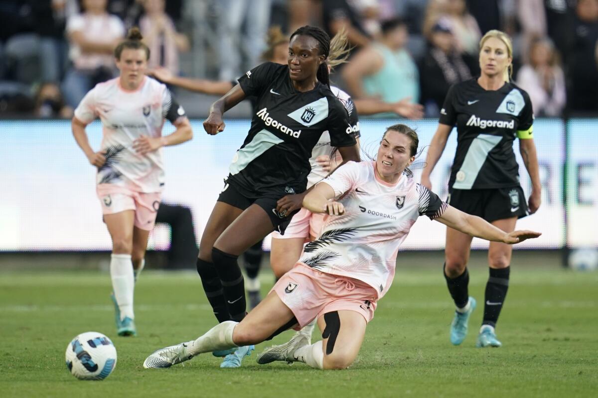 NWSL players Ifeoma Onumonu and  Vanessa Gilles battle for the ball.