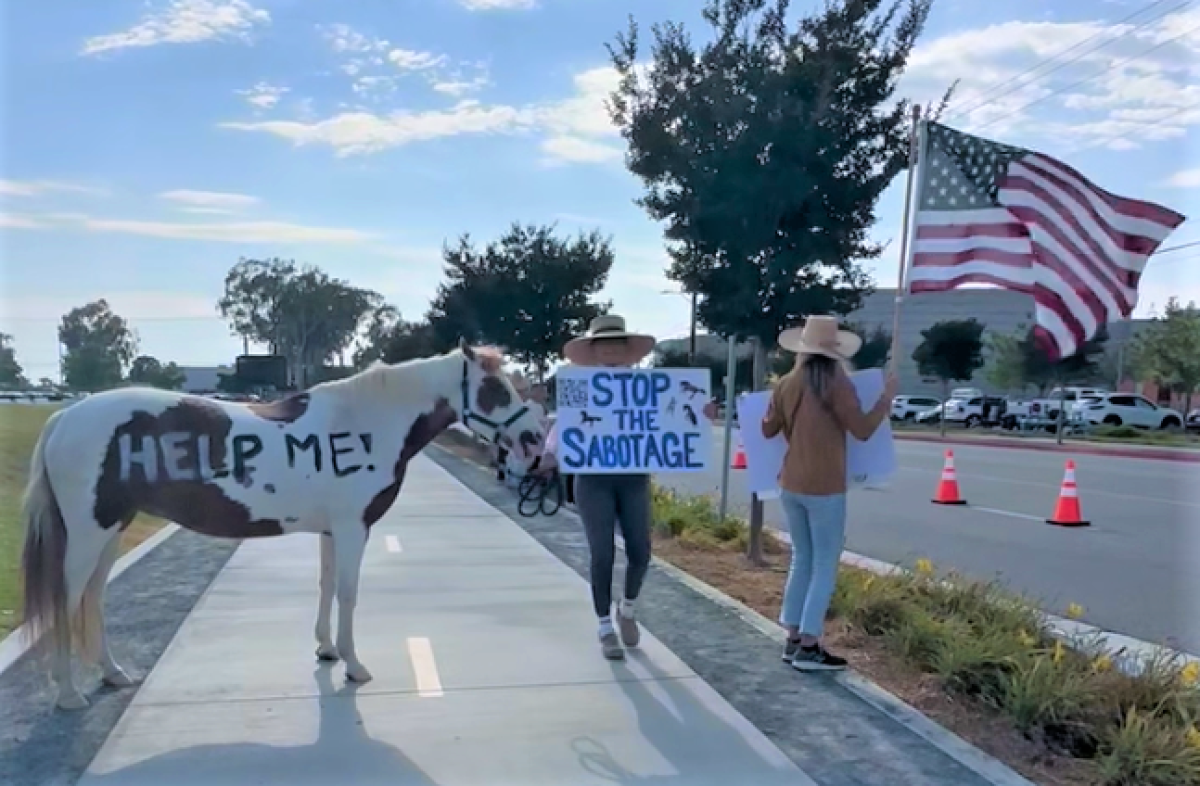 Equestrian protesters gather Thursday near the O.C. fairgrounds in Costa Mesa.