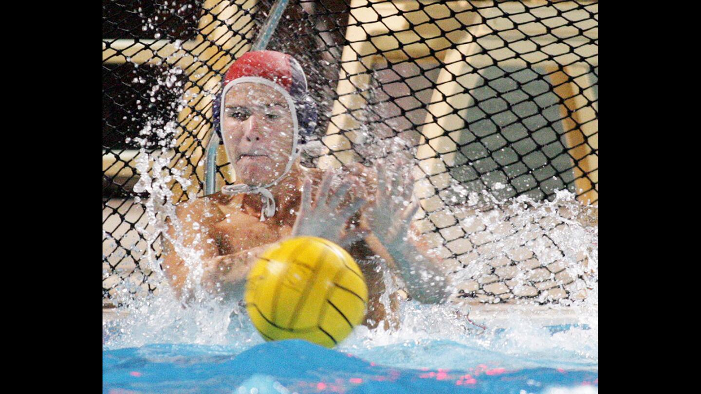 Crescenta Valley's Logan Goddard makes a stop against Santa Monica in a CIF Southern Section Division IV boys water polo match at Adolfo Camarillo High School on Wednesday, November 18, 2015. Crescenta Valley advances to the finals with a score of 10-7. (Tim Berger/Staff Photographer)