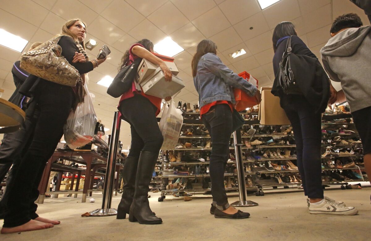 Shoppers line up to buy discounted shoes at Macy's at the South Coast Plaza mall the morning of Black Friday.