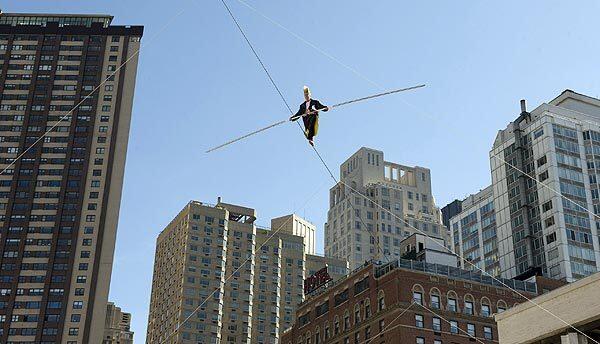 Bello Nock of the Big Apple Circus performs his high-wire act over the fountain at Lincoln Center in New York. The circus will be in the city from Oct. 22 through Jan. 18.