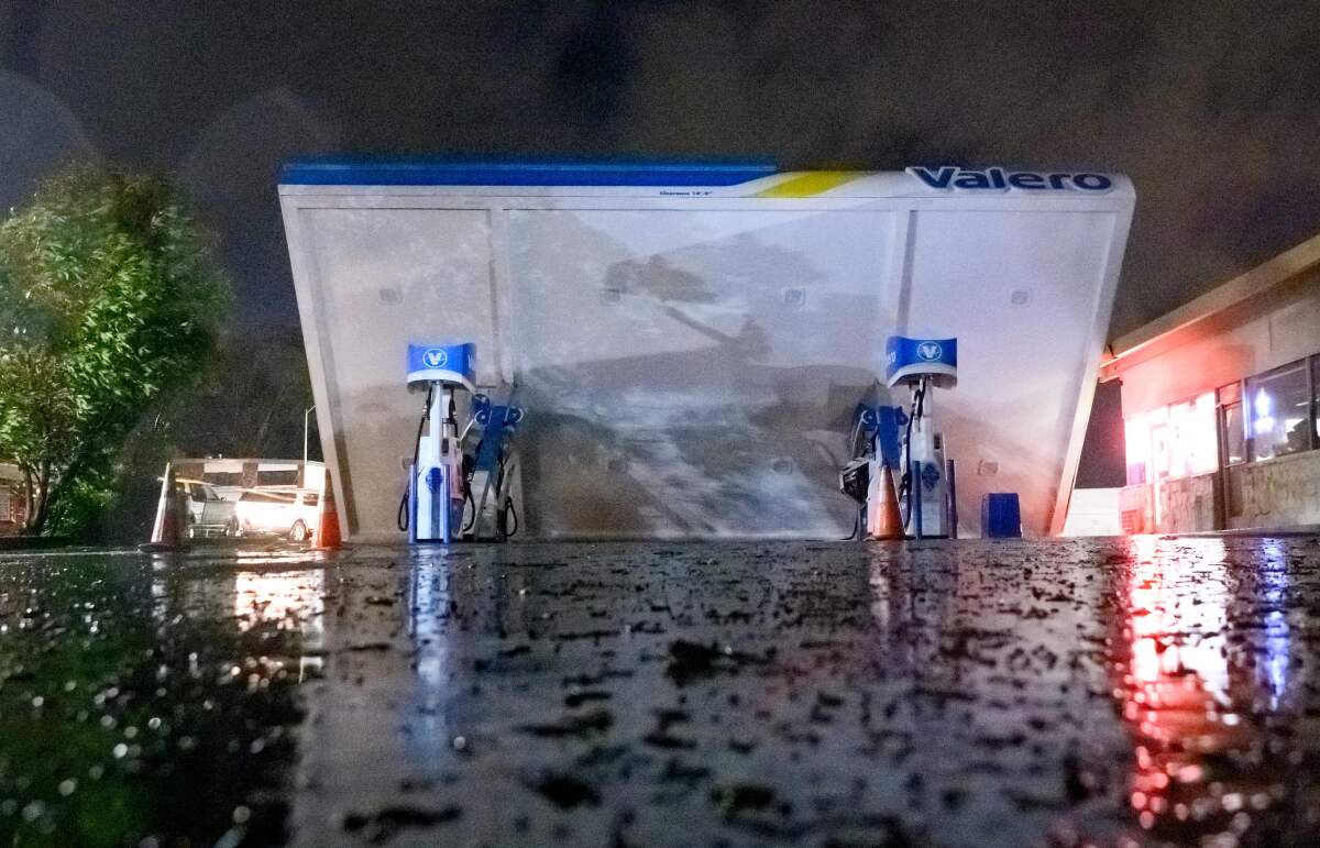 A damaged Valero gas station creaks in the wind during a massive "bomb cyclone" rain storm in South San Francisco.