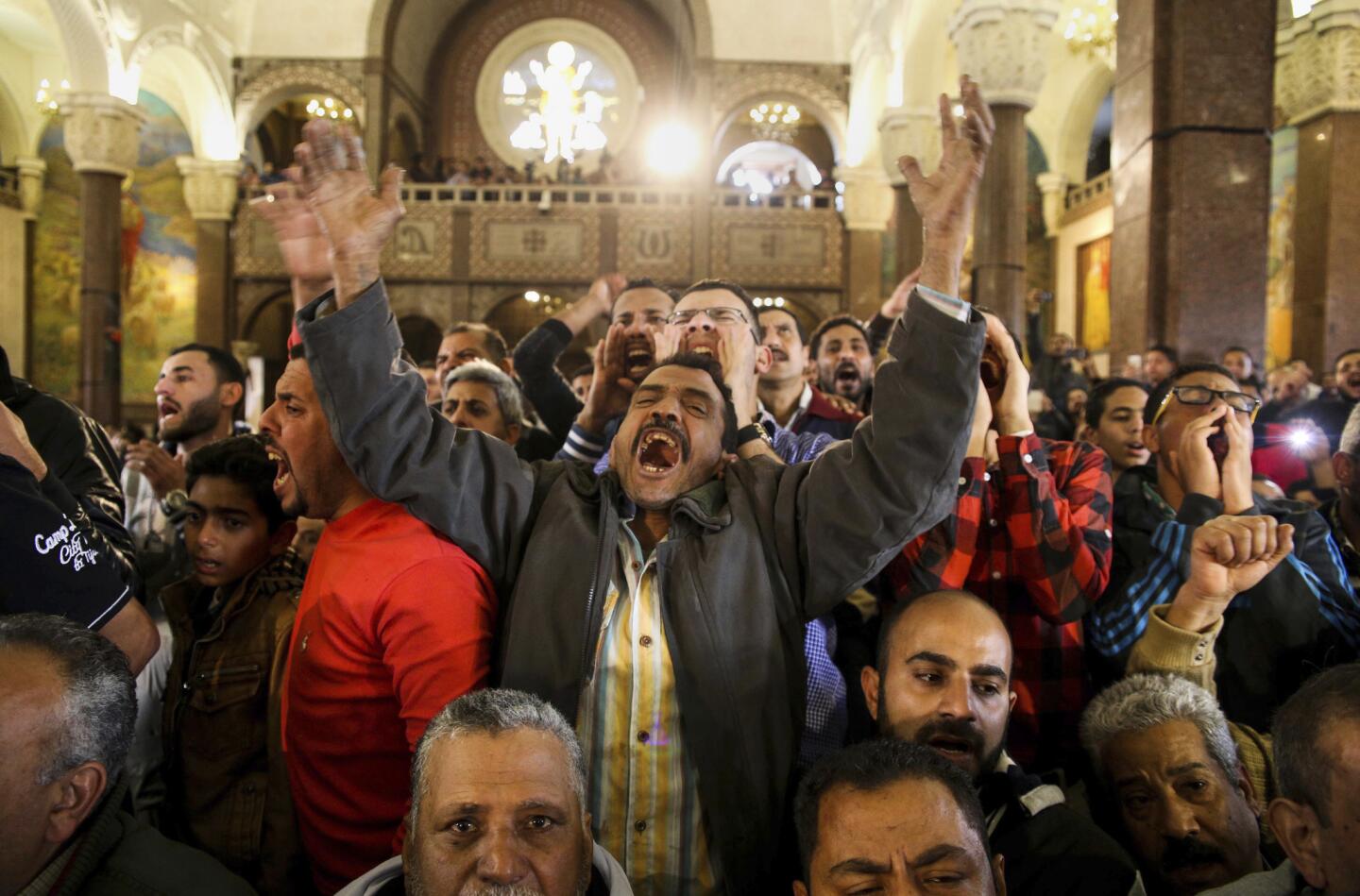 Men react during the funeral for those killed in a Palm Sunday church attack in Alexandria, Egypt. Egyptian Christians buried their dead on Monday, a day after Islamic State suicide bombers killed at least 45 people in coordinated attacks targeting Palm Sunday services in two cities.