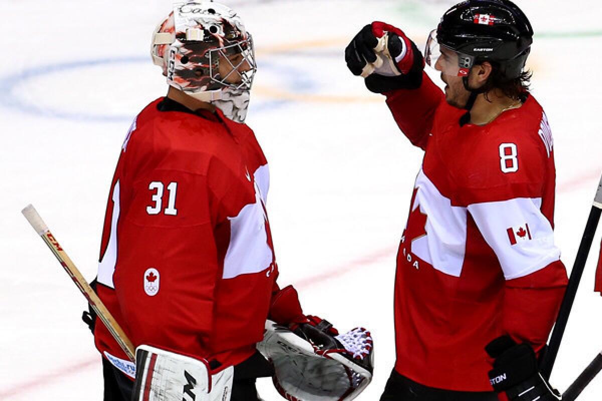 Canada defenseman Drew Doughty, right, celebrates with goalkeeper Carey Price after a 3-1 victory over Norway at the Sochi Olympics.