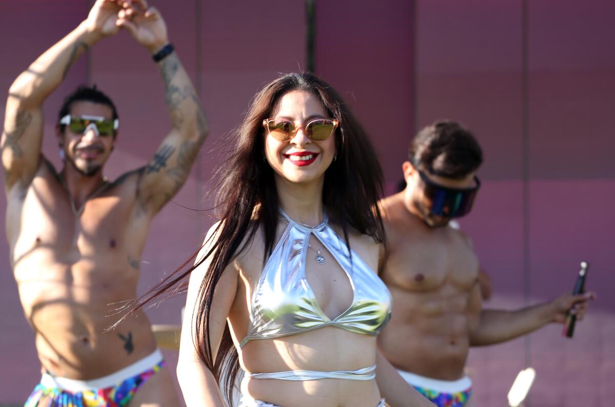 Dancer Lesly Mayen dances with Jacob Rojas and Uriel Ramirez at Lang Park.