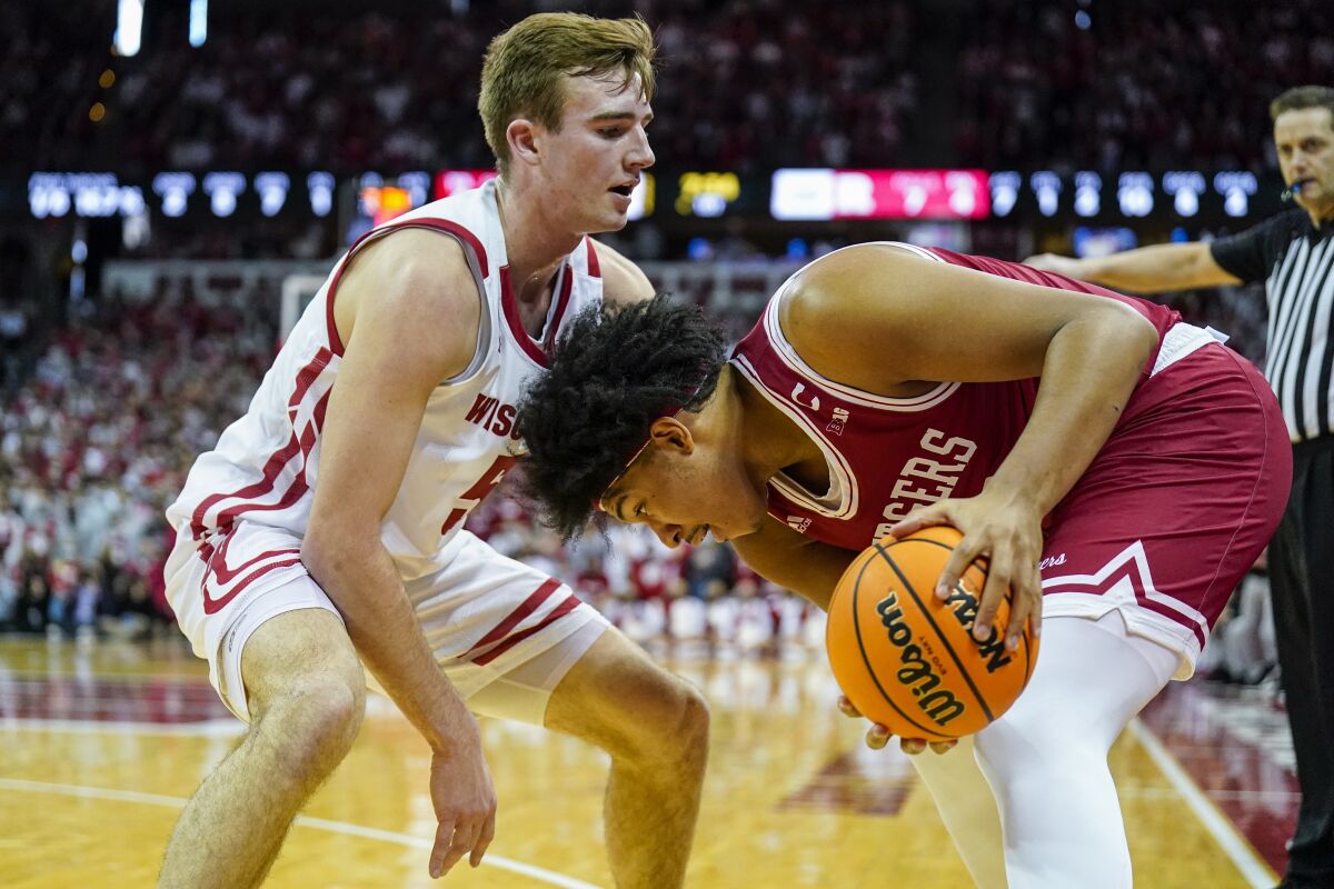 Rutgers' Ron Harper, right, maneuvers around Wisconsin's Tyler Wahl (5) during the first half of an NCAA college basketball game Saturday, Feb. 12, 2022, in Madison, Wis. (AP Photo/Andy Manis)