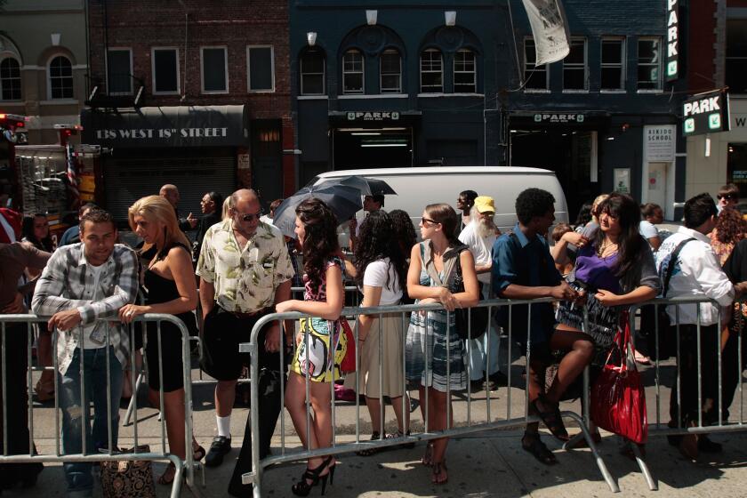 Hundreds of hopefuls stand in line to try out as extras for the movie "Sex and the City 2" in New York City. 