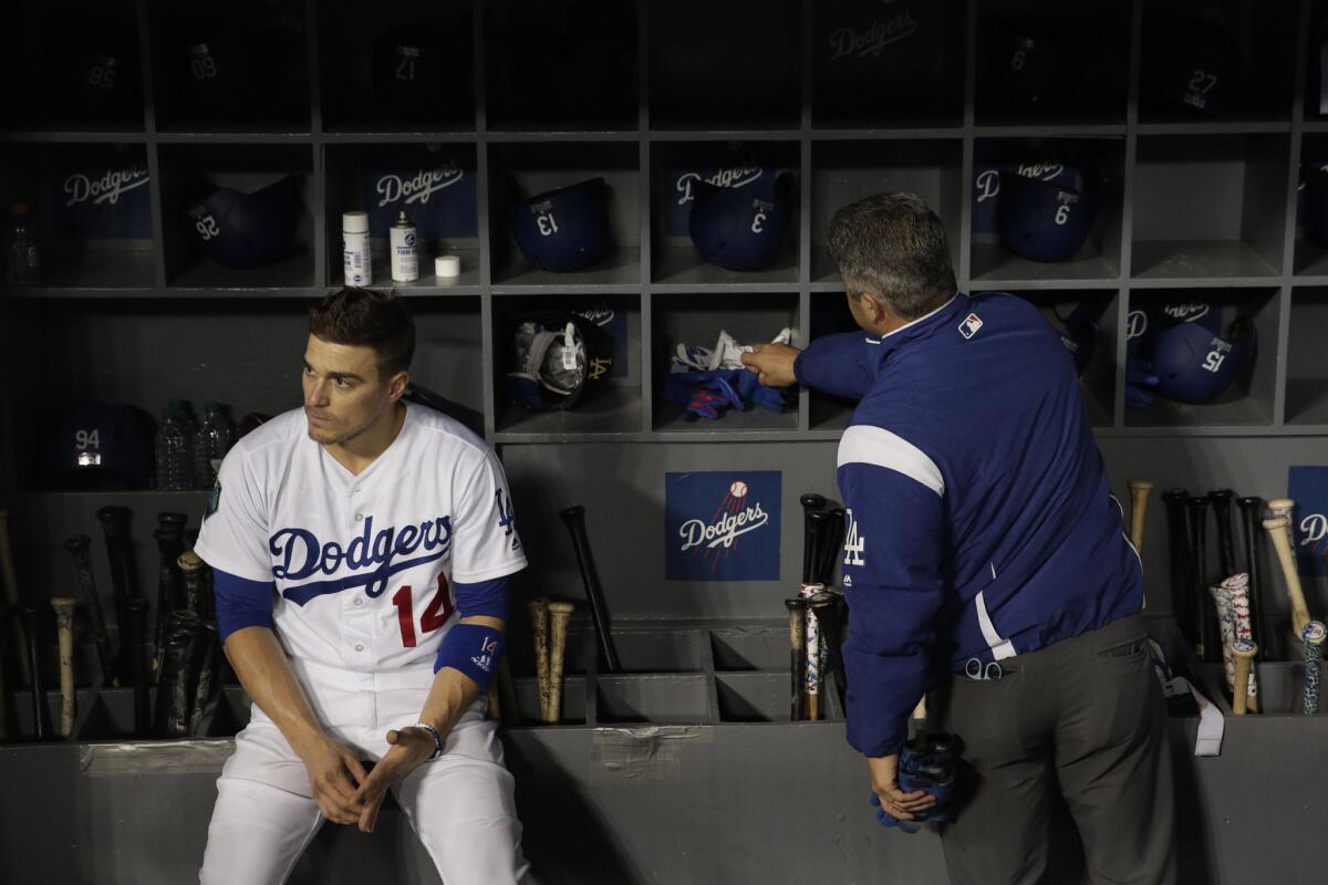 The Dodgers' Enrique Hernandez sits in the dugout after the team's 5-1 loss to the Boston Red Sox in Game 5 of the World Series on Sunday.