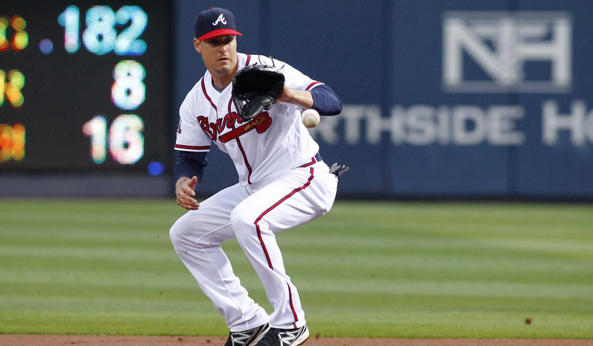 Former Atlanta Braves second baseman Kelly Johnson fields a ground ball in the first inning against the Philadelphia Phillies on May 12. The Mets reacquired Johnson on Wednesday.