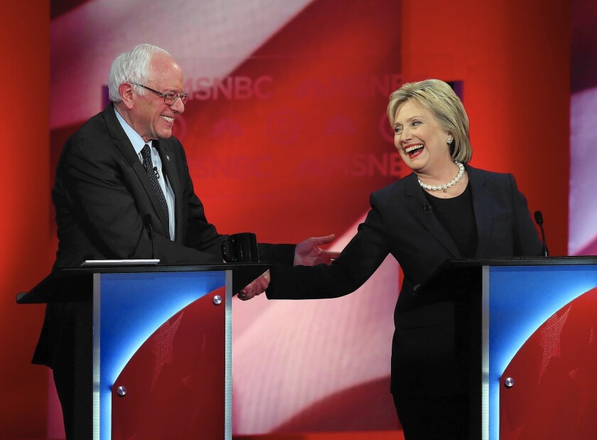 The only remaining Democratic candidates, Bernie Sanders and Hillary Clinton, share a friendly exchange during an often-heated debate in Durham, N.H.