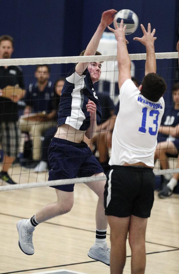 Flintridge Prep's Cole Bernard hits a kill against the extended arms of Windward's Charles Rogers in the CIF Southern Section Division IV semifinal volleyball match at Windward School in Los Angeles on Wednesday, May 8, 2019. Flintridge Prep lost the match 3-2, playing to the final point losing the last set 18-16.