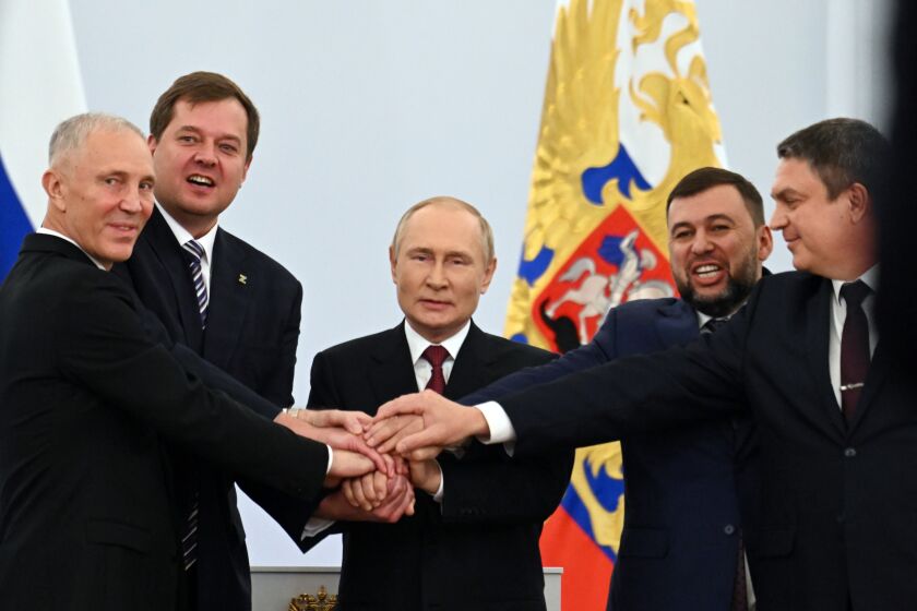From left, Moscow-appointed head of Kherson Region Vladimir Saldo, Moscow-appointed head of Zaporizhzhia region Yevgeny Balitsky, Russian President Vladimir Putin, Denis Pushilin, leader of self-proclaimed Donetsk People's Republic and Leonid Pasechnik, leader of self-proclaimed Luhansk People's Republic pose for a photo during a ceremony to sign the treaties for four regions of Ukraine to join Russia, at the Kremlin in Moscow, Friday, Sept. 30, 2022. The signing of the treaties making the four regions part of Russia follows the completion of the Kremlin-orchestrated "referendums." (Grigory Sysoyev, Sputnik, Government Pool Photo via AP)