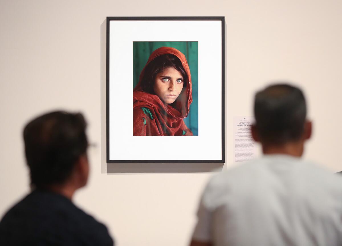 Two guests view Steve McCurry's iconic "The Afghan Girl" at Bower's Museum.