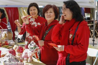 490244-sd-me-chinese-new-year San Diego, CA February 08, 2020 Members of the Chinese Consolidated Benevolent Society (CCBS) greet attendees of the Gaslamp Quarter Chinese New Year Celebration. This year marks the Year of the Rat. From left are: Lan Fen, Andrea Chu and Cory Uyeji. Fen and Chu are holding lion puppets that were for sale as a fundraiser for the organization, located in the 400 block #rd Ave, downtown. © 2020 Nancee E. Lewis / Nancee Lewis Photography.