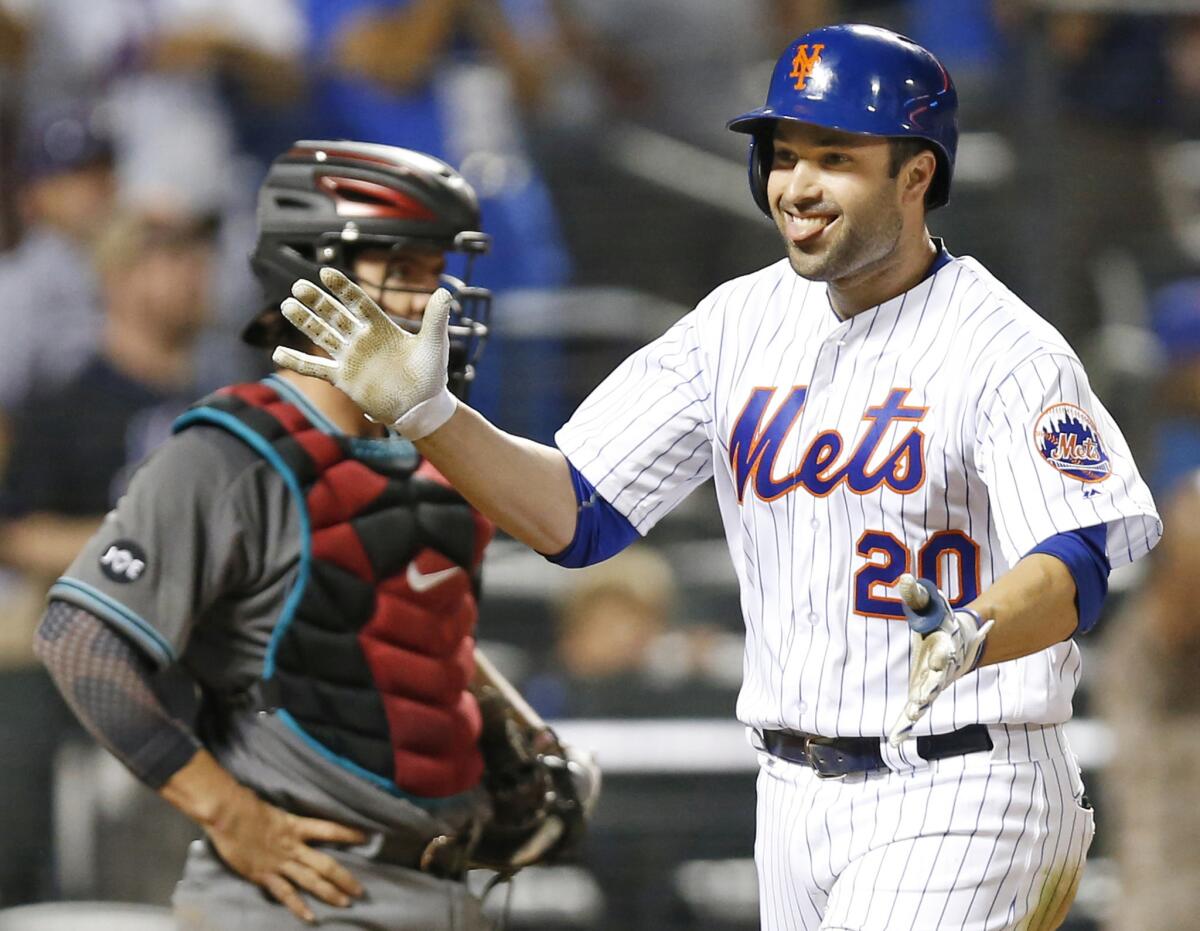 Mets second baseman Neil Walker (20) smiles in front of Diamondbacks catcher Tuffy Gosewisch after hitting a two-run home run during the sixth inning on Aug. 9.