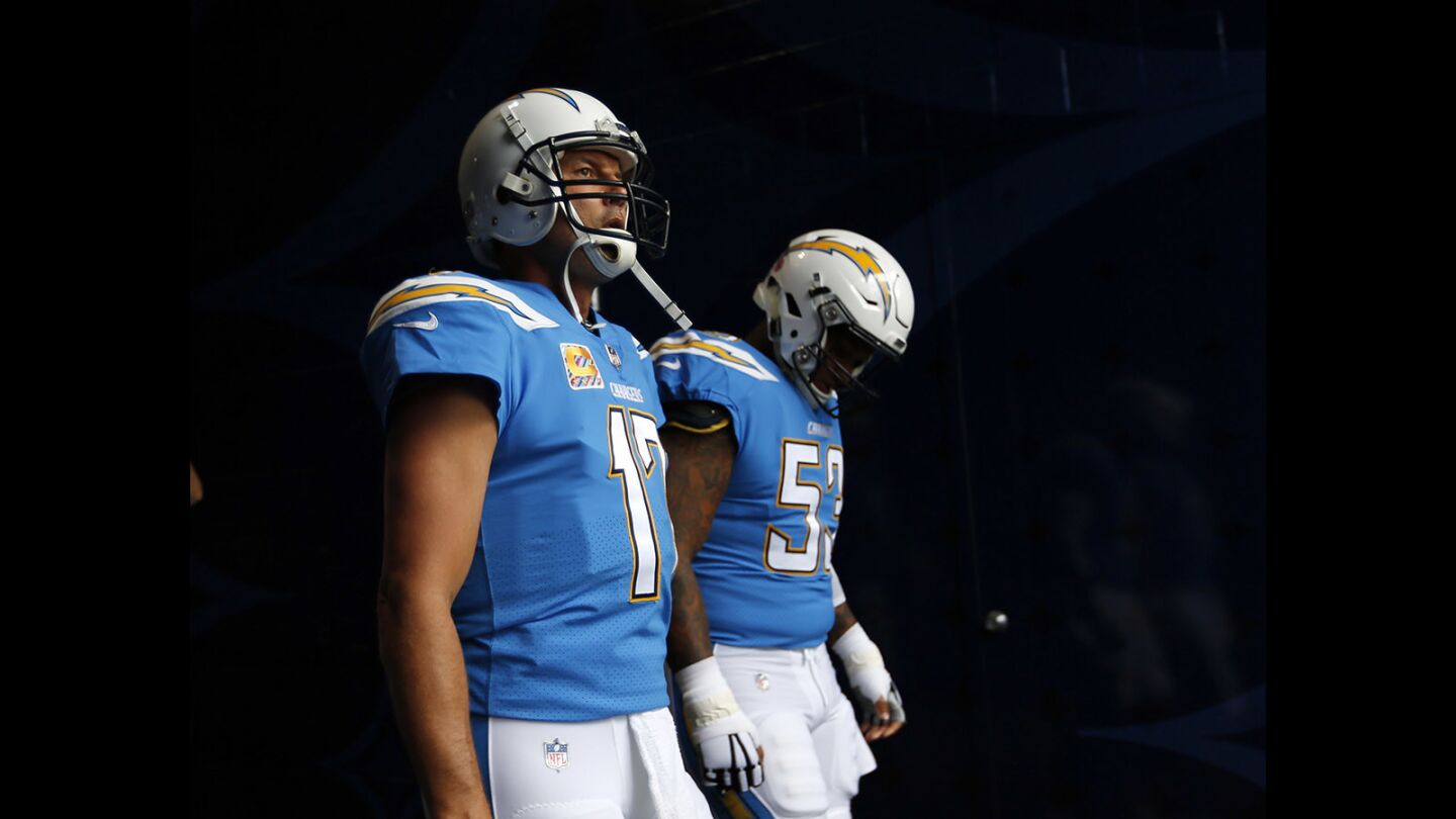 Los Angeles Chargers quarterback Philip Rivers and Mike Pouncey (53) walks out to a game against the Oakland Raiders at the StubHub Center in Carson on Oct. 7, 2018. (Photo by K.C. Alfred/San Diego Union-Tribune)