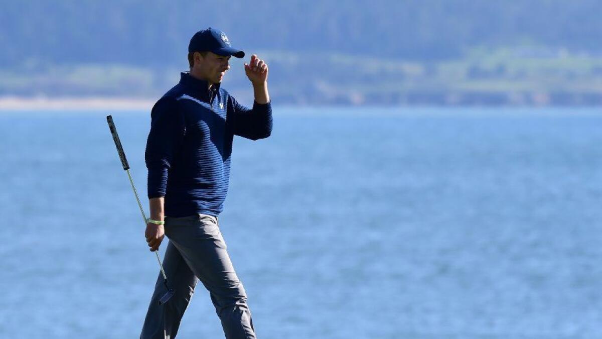 Jordan Spieth acknowledges the crowd on the 18th hole during the final round of the AT&T Pebble Beach Pro-Am on Feb. 12.