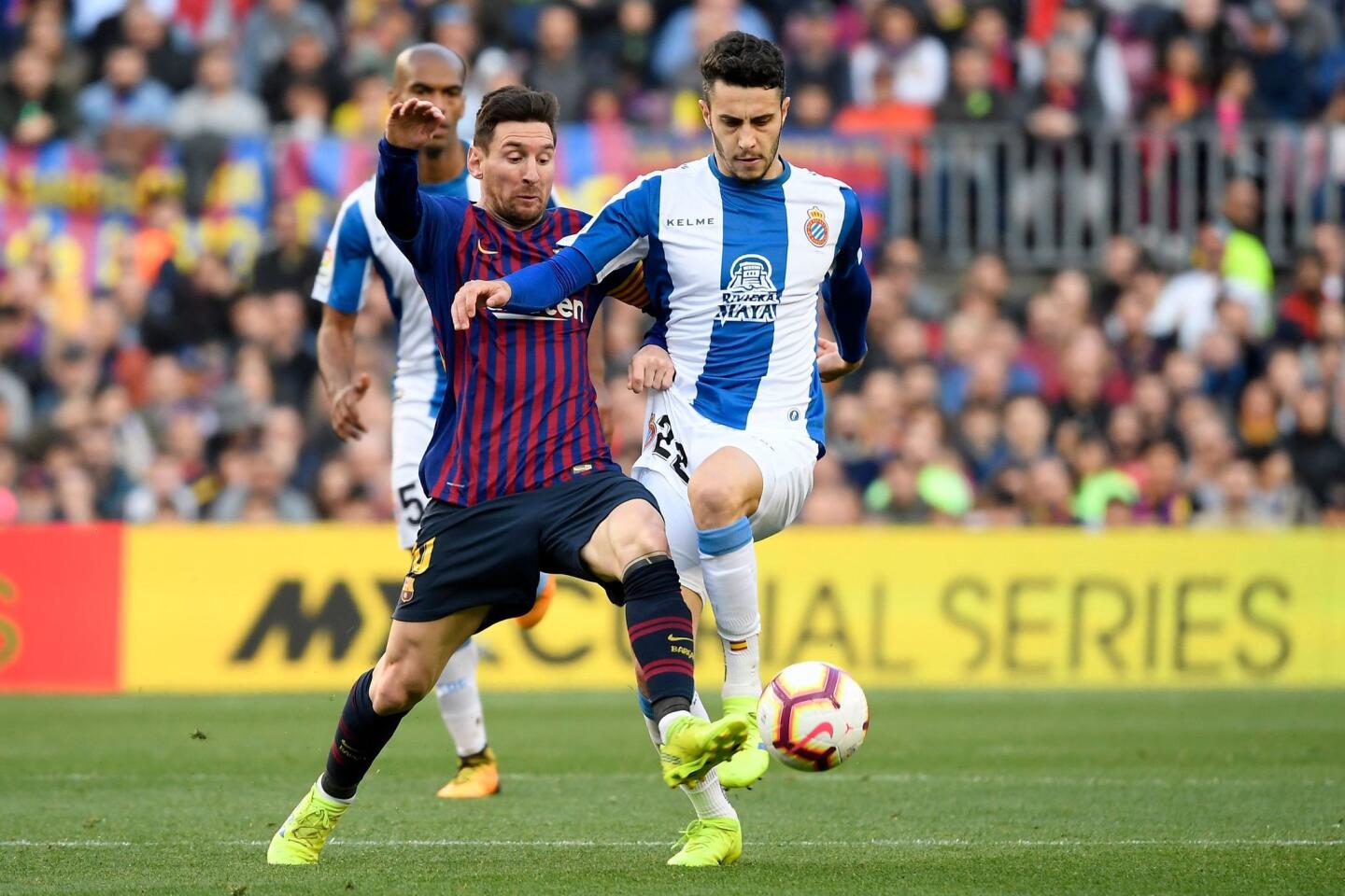 Barcelona's Argentinian forward Lionel Messi (L) challenges Espanyol's Spanish defender Mario Hermoso during the Spanish league football match between FC Barcelona and RCD Espanyol at the Camp Nou stadium in Barcelona on March 30, 2019. (Photo by LLUIS GENE / AFP)LLUIS GENE/AFP/Getty Images ** OUTS - ELSENT, FPG, CM - OUTS * NM, PH, VA if sourced by CT, LA or MoD **