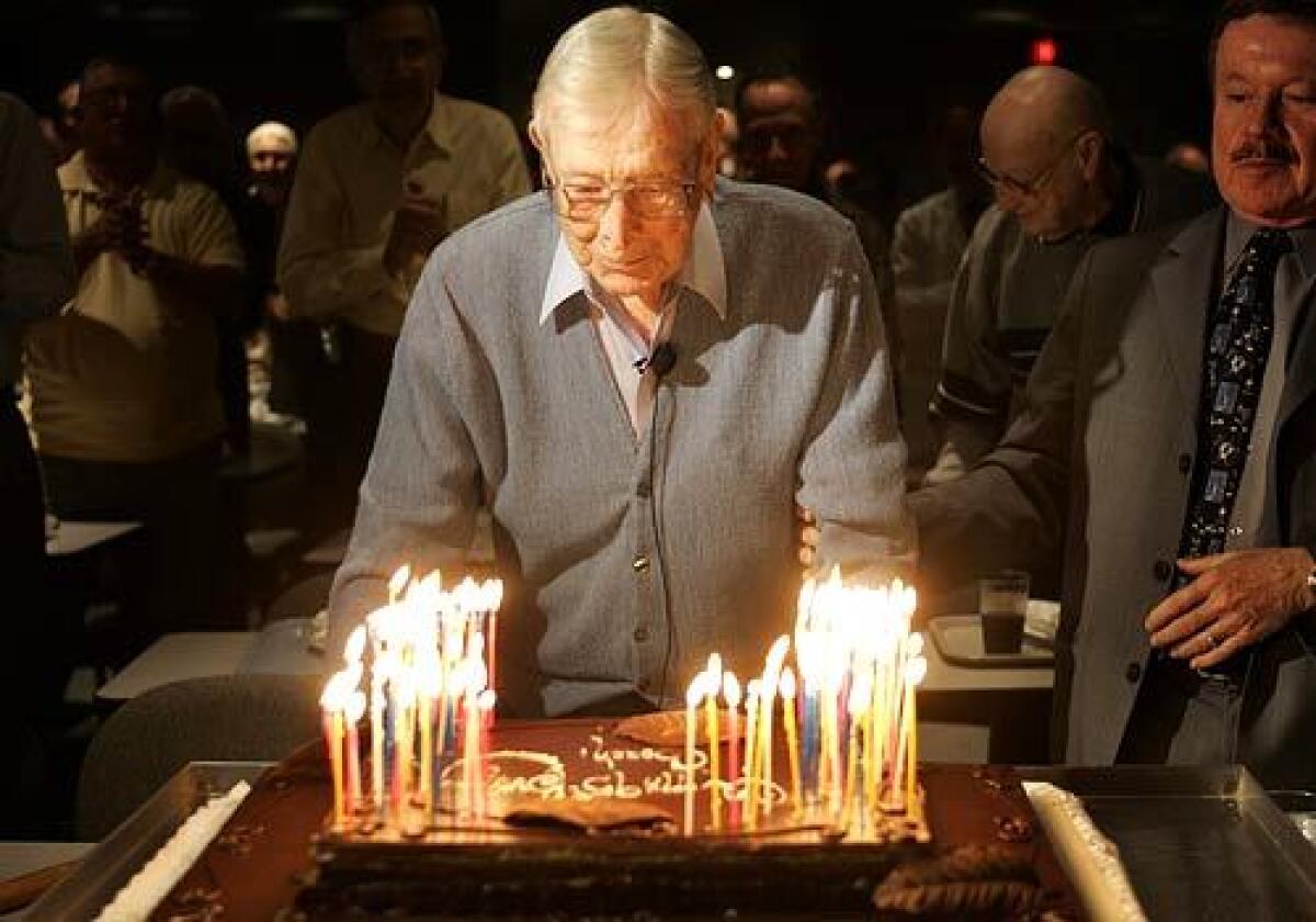 Wooden, two days before turning 95, prepares to blow out the candles on his birthday cake at Encino-Tarzana Regional Medical Center. See full story