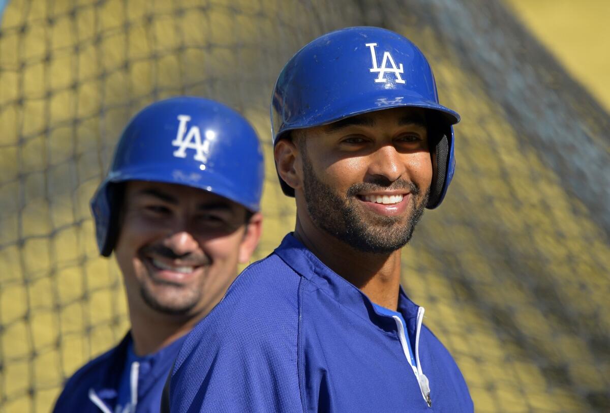 Dodgers outfielder Matt Kemp, right, smiles while taking part in batting practice with teammate Adrian Gonzalez in April. Kemp was activated off the disabled list by the Dodgers on Monday.