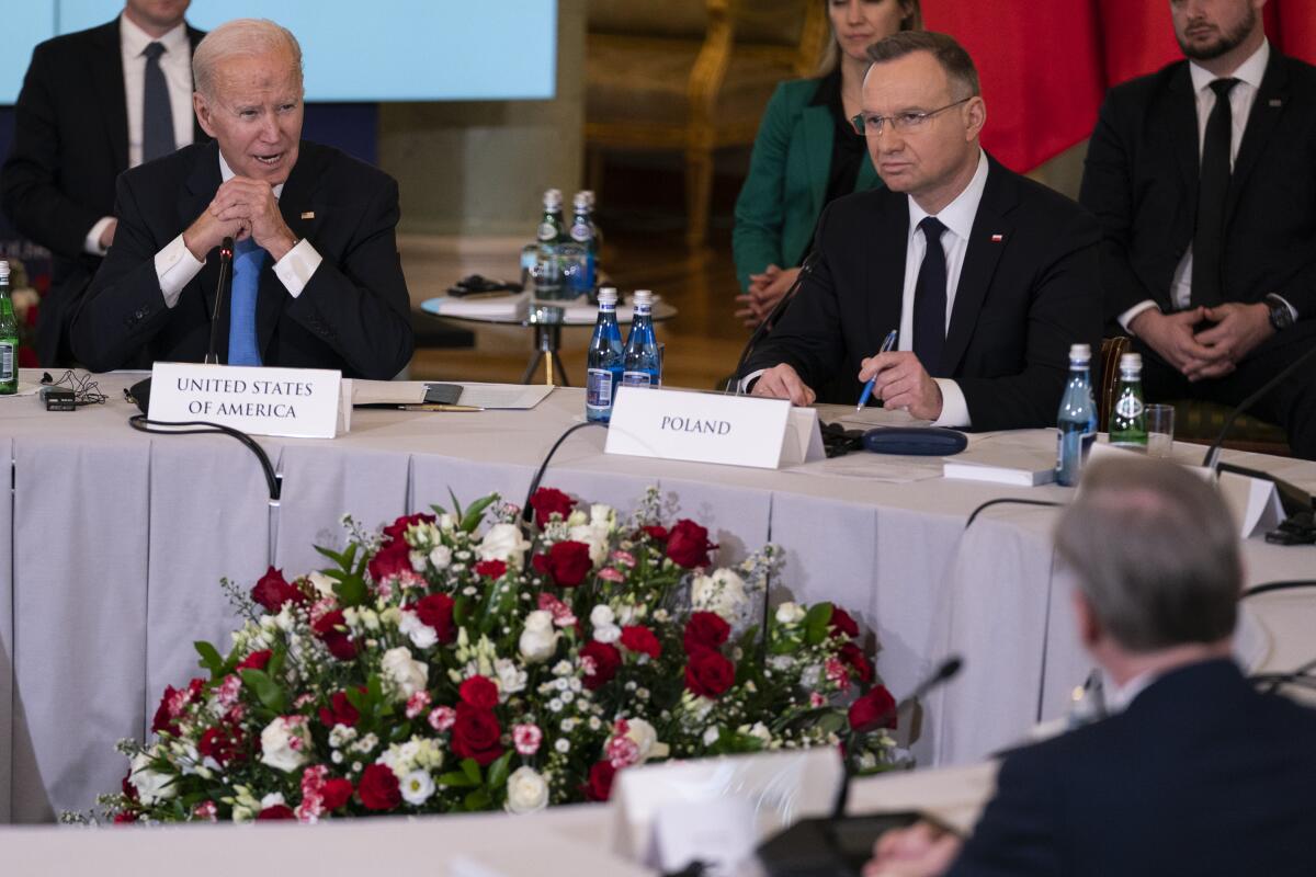 President Biden speaks at a meeting with other leaders. 