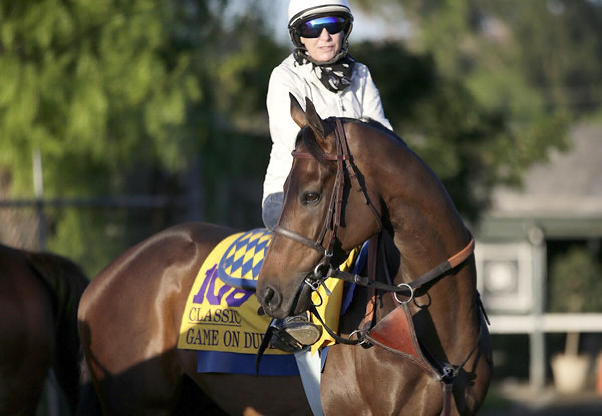 Game On Dude, with exercise rider Dana Barnes atop, gets ready for a morning workout at Santa Anita Park on Wednesday.