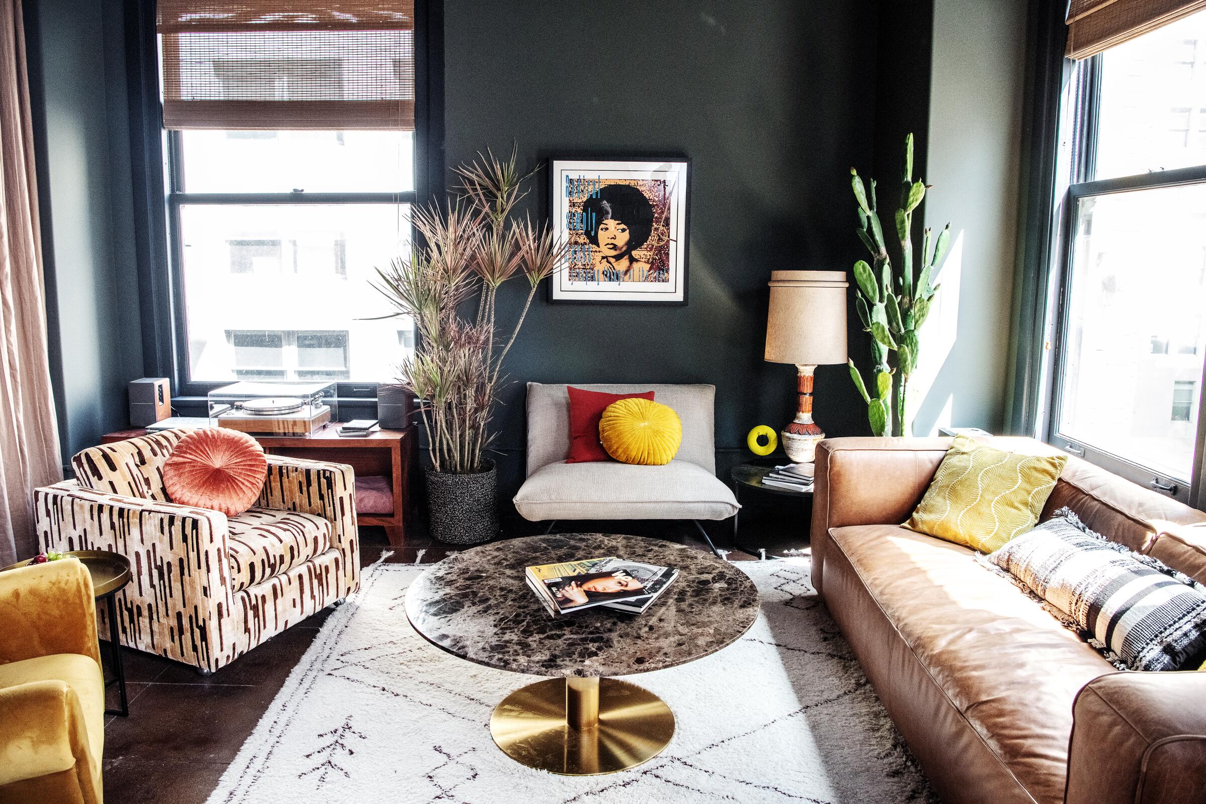 A living room furnished with a couch, three lounge chairs, a coffee table, a lamp and some plants 