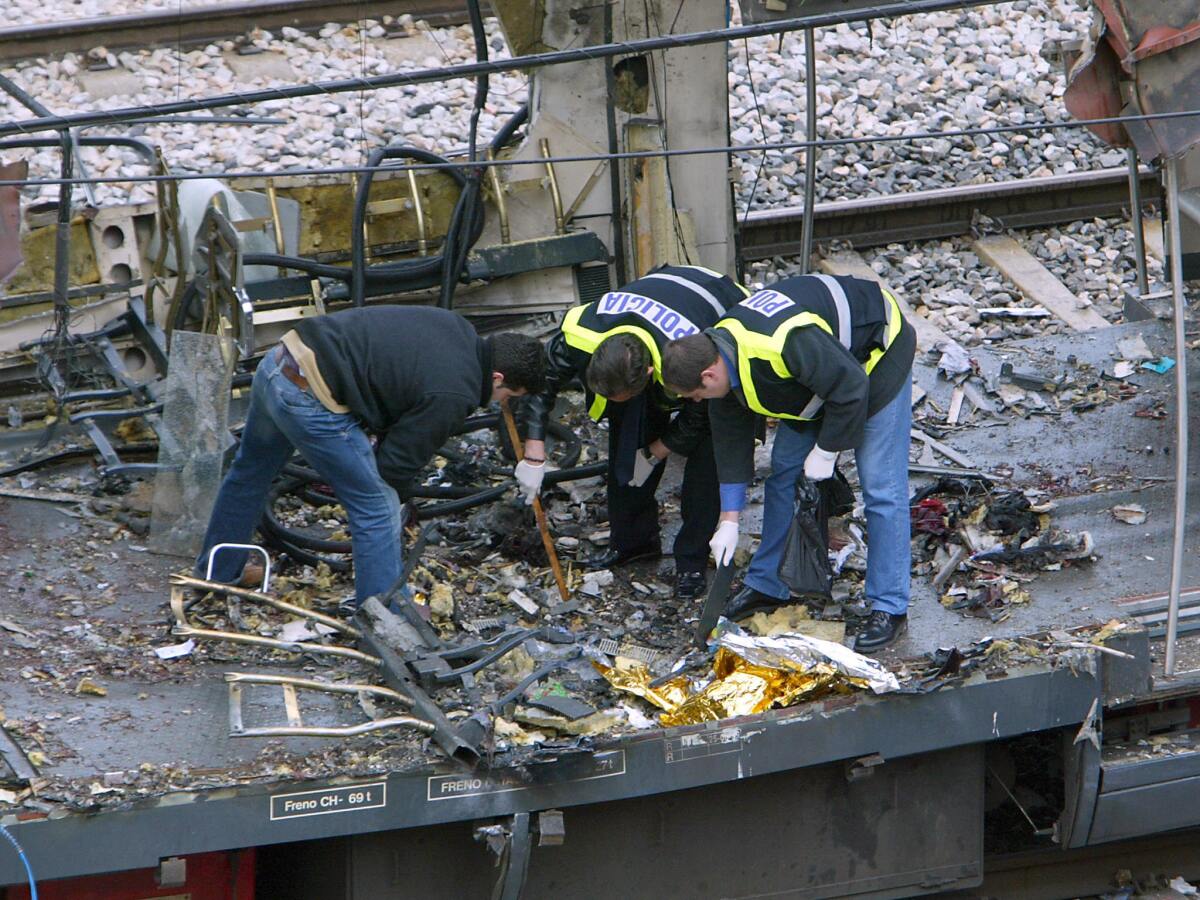 Forensic experts inspect the trains that exploded at the Atocha train station in Madrid.