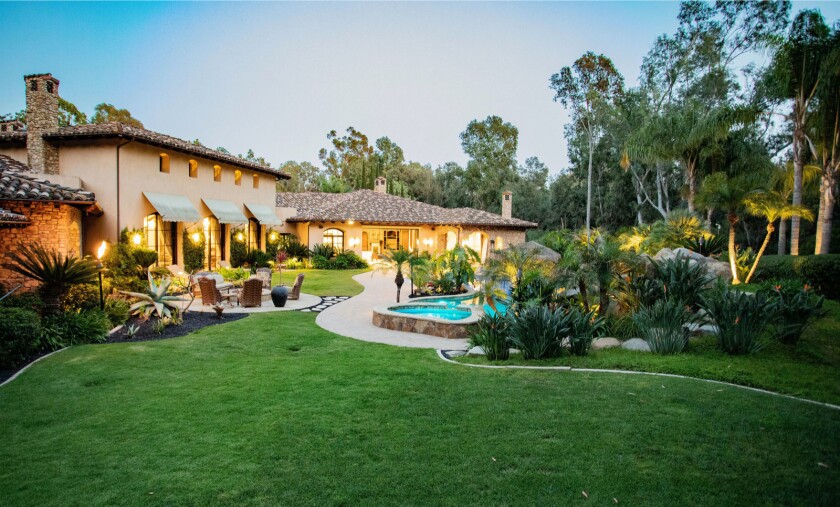 The property holds a 10,000-square-foot home with a resort-style backyard.