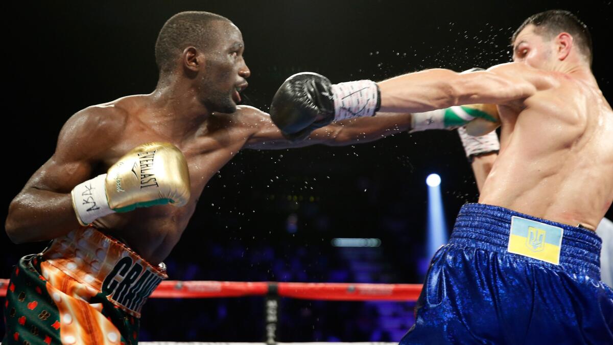 Terence Crawford punches Viktor Postol during their fight on July 23.