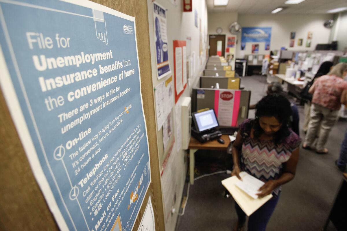 A poster at a job center explains ways to file for unemployment benefits 