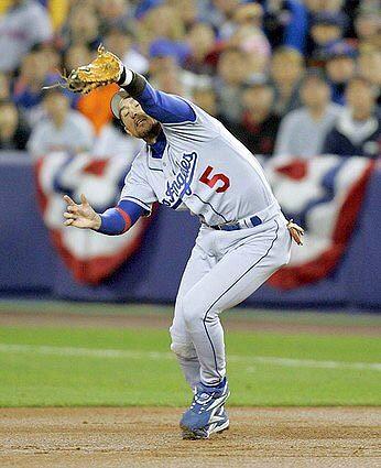 GAME 2: Dodgers first baseman Nomar Garciaparra, who would leave the game in the sixth inning after injuring his leg, almost lets an infield fly get away in the first inning.
