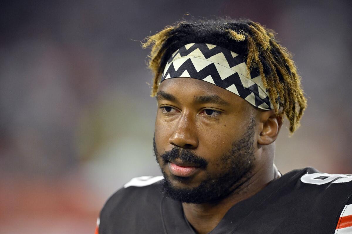 FILE - Cleveland Browns defensive end Myles Garrett (95) stands on the field during an NFL football game against the Pittsburgh Steelers, on Thursday, Sept. 22, 2022, in Cleveland. The Browns defensive star stayed home to rest and recover from multiple injuries suffered in a frightening car crash as his status for Cleveland's game on Sunday in Atlanta remains in doubt. Garrett was not at the team's facility Wednesday, Sept.28, 2022, two days after the All-Pro rolled over his Porsche in a single-car accident on a rural road near home. He suffered a sprained shoulder, strained biceps, cuts and bruises in the wreck. (AP Photo/David Richard, File)