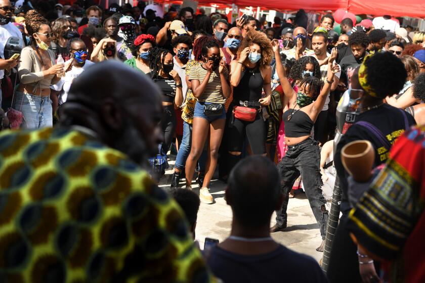 LOS ANGELES, CALIFORNIA JUNE 19, 2020-A woman dances to the music during a Juneteenth celebration at Leimert Park Friday. (Wally Skalij/Los Angeles Times)